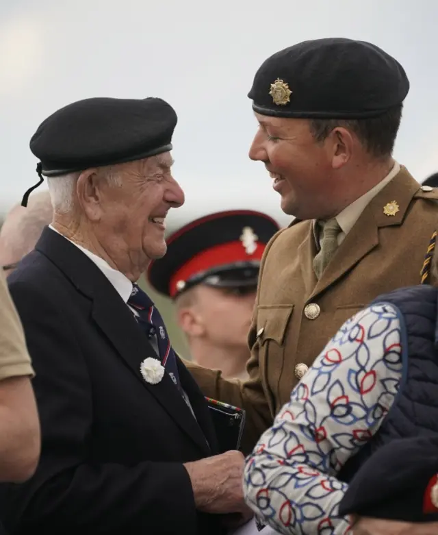 A veteran and serving soldier embrace