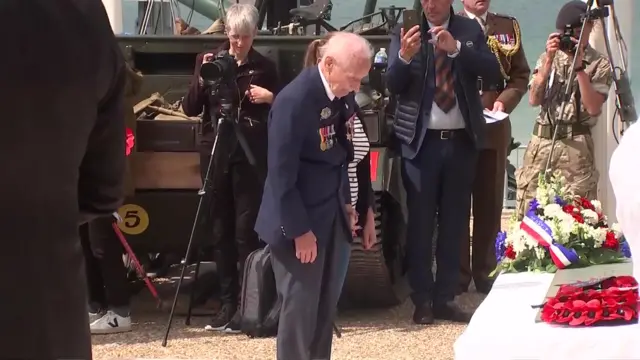 A veteran lays a wreath