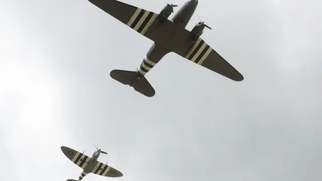 A Douglas C-47 Skytrain is escorted by a Spitfire