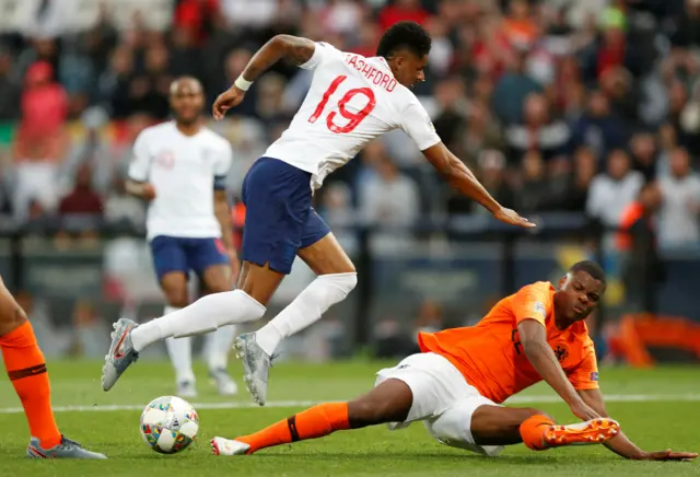 Marcus Rashford is challenged by Denzel Dumfries