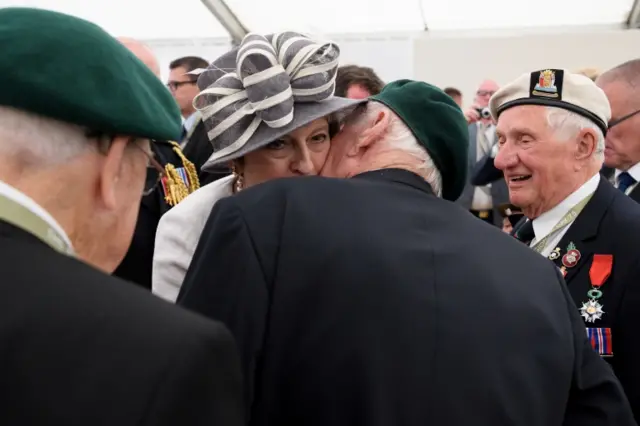 Theresa May getting kissed at Bayeux D-Day event