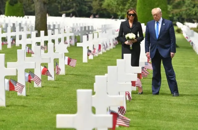 US President Trump and the First Lady visiting graves at the Normandy American Cemetery