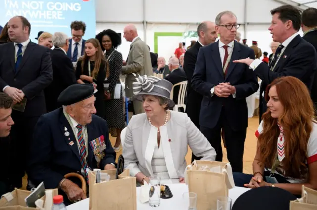 Theresa May speaking to veteran Leslie Stocking