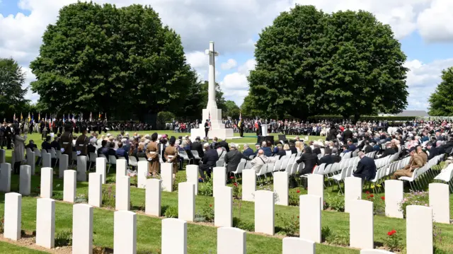 Guests attend a ceremony at the Bayeux war cemetery