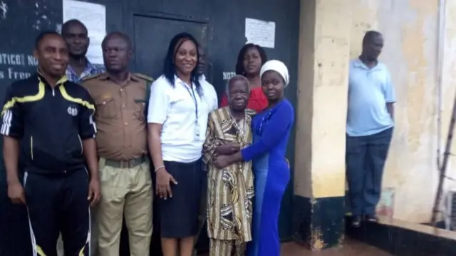 Celestine Egbunuche standing outside the prison with his daughter and representatives  of Global Society for Anti Corruption