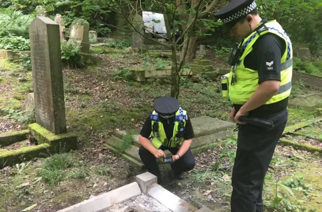 POLICE AT SCENE OF GRAVESTONES