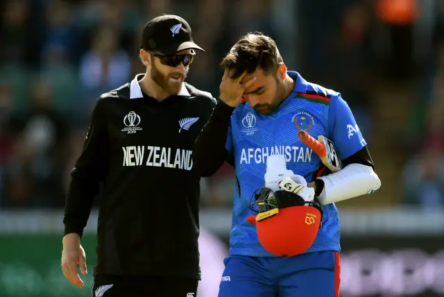 New Zealand captain Kane Williamson checks on Rashid Khan after he was hit in the helmet in being bowled