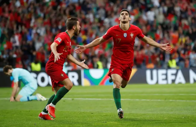 Guedes and Bernardo Silva celebrate