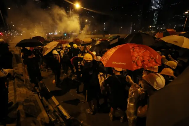 Many protesters seek cover under umbrellas in Hong Kong