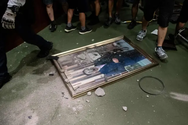 A smashed portrait of the President of the Legislative Council, Andrew Leung