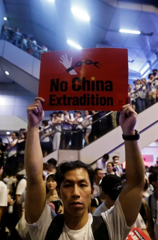 A demonstrator in Hong Kong holds a poster that says "No China extradition". Photo: June 2019