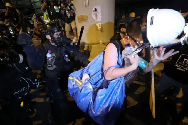 Riot police chase protesters in Hong Kong