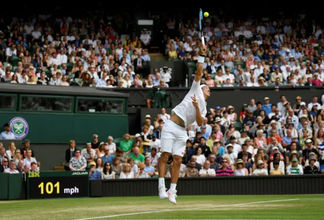 Kei Nishikori serves