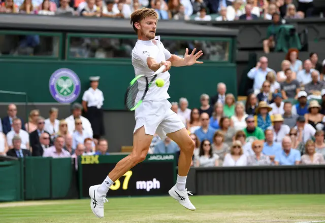David Goffin makes a shot from behind the baseline