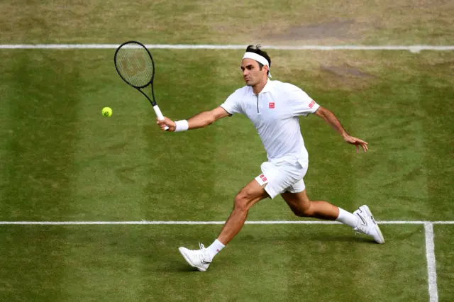 Roger Federer hits a volley