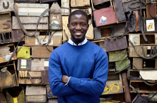 Ibrahim in front of his work.
