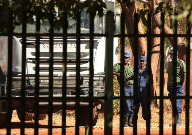 Police stand guard outside the court in Harare on Wednesday where Job Sikhala was expected to appear.