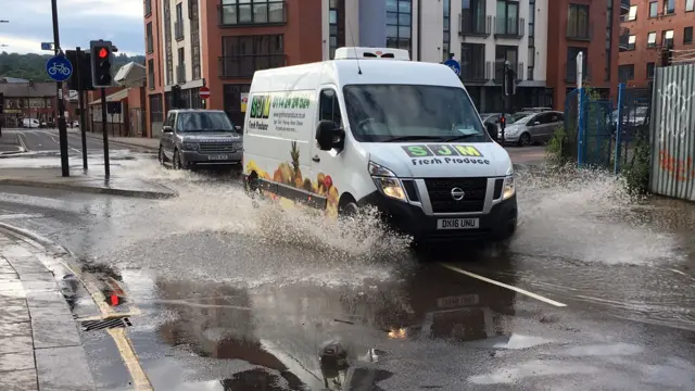 A van driving through water