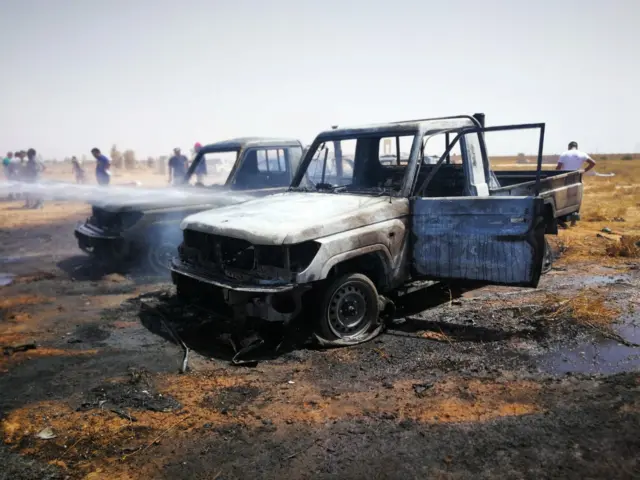 Damaged cars are seen at the site where a car bomb hit a funeral of a former senior military commander at Huwari cemetery in Benghazi, Libya.