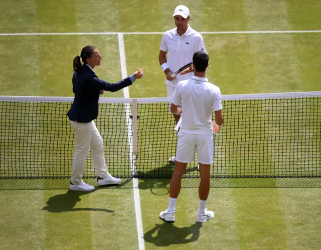 The coin toss for the serve in the first men's semi-final on Centre Court f