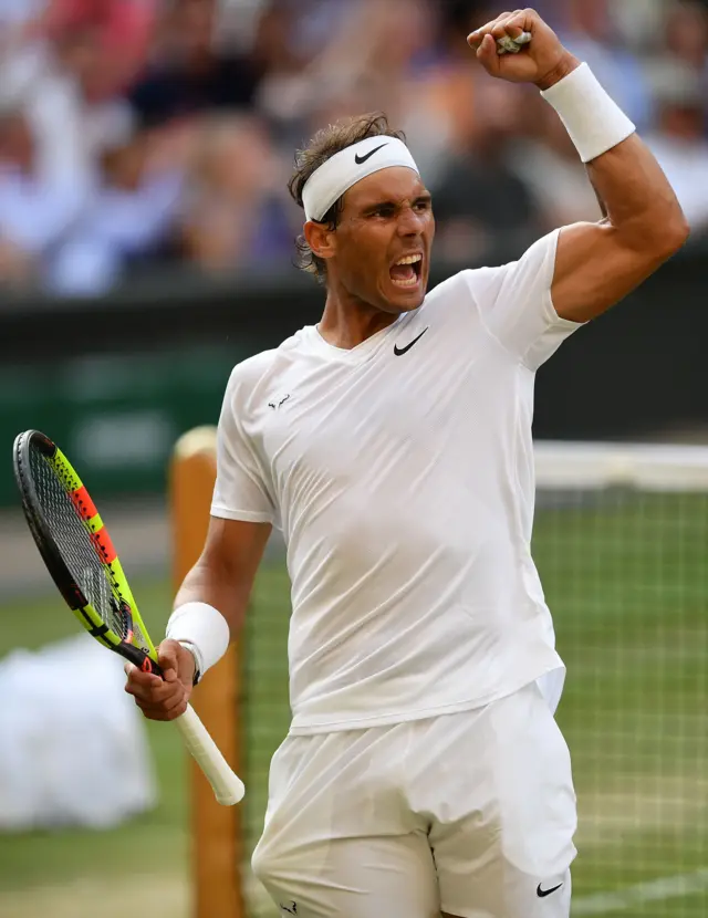 Rafael Nadal roars after saving two match points to hold serve