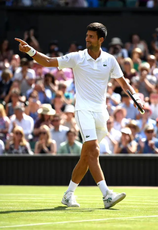 Novak Djokovic points to the crowd