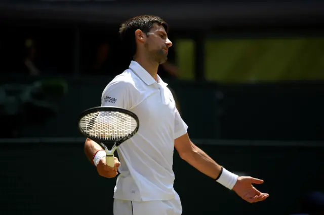 Novak Djokovic swings his arms in frustration