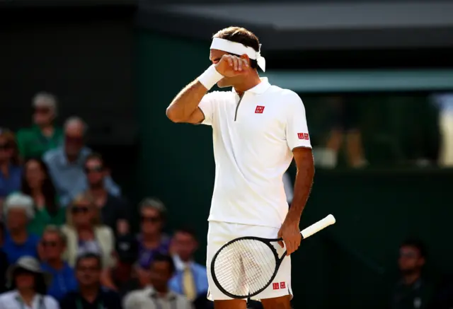 Roger Federer wipes his brow