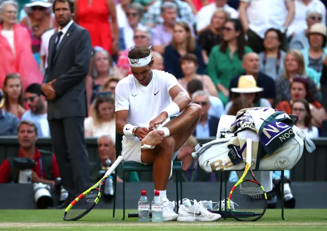 Rafael Nadal takes tape off his ankle