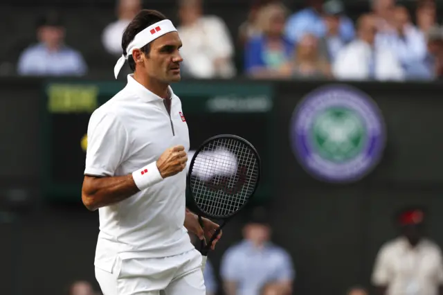 Roger Federer reacts to holding his serve