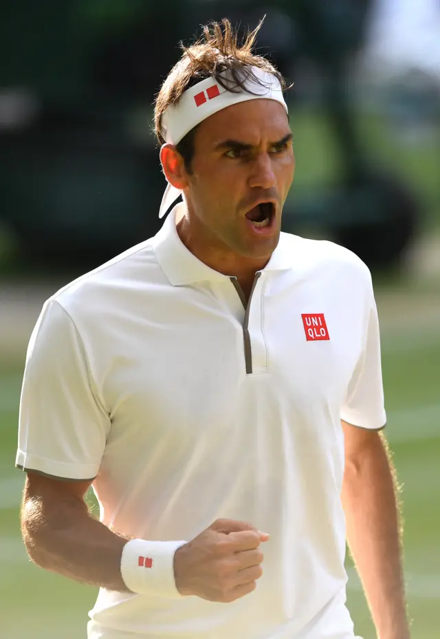 Roger Federer roars after holding his serve