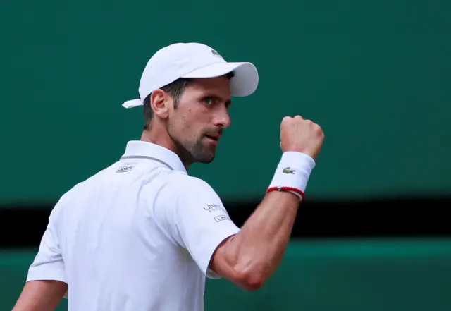 Novak Djokovic celebrates winning the first set