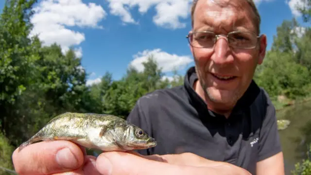 Mat Faulkner holding the stickleback