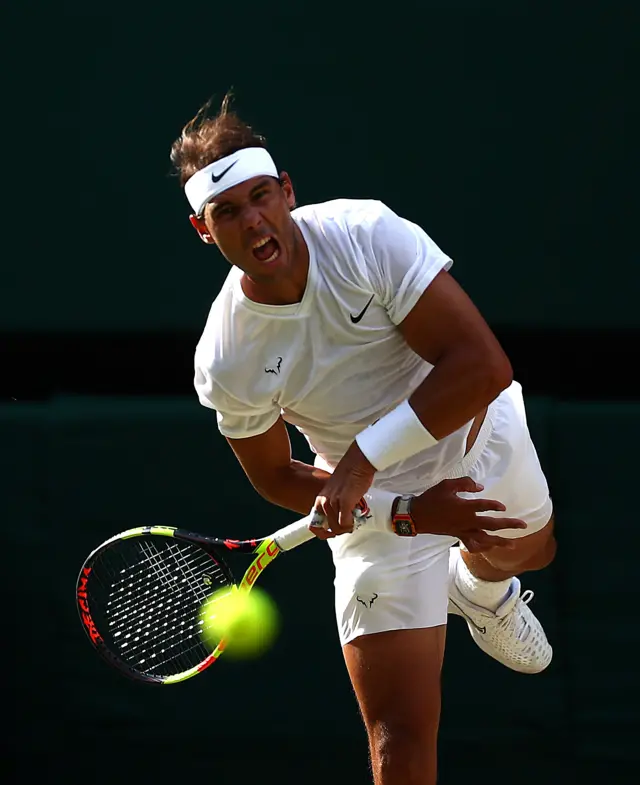 Rafael Nadal serves