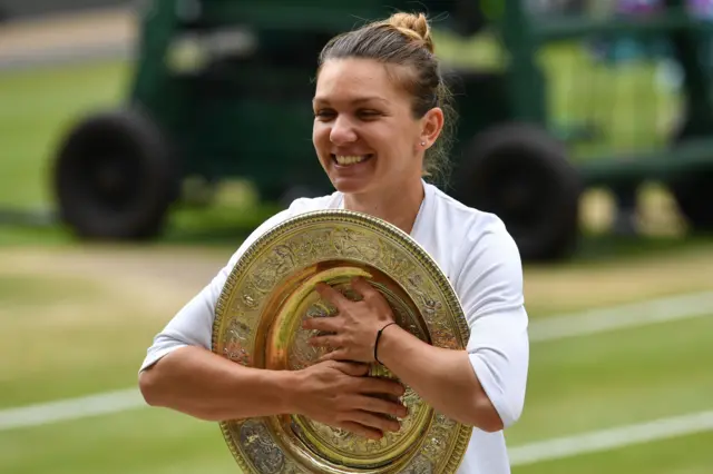 Simona Halep hugs the Venus Rosewater Dish