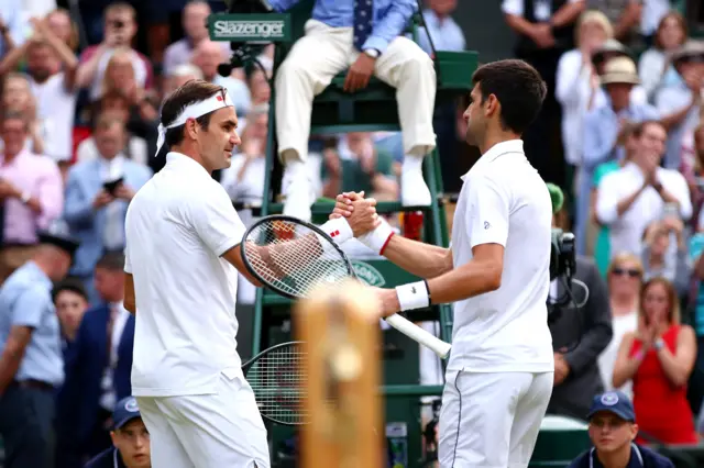 Federer and Djokovic shake hands at the net