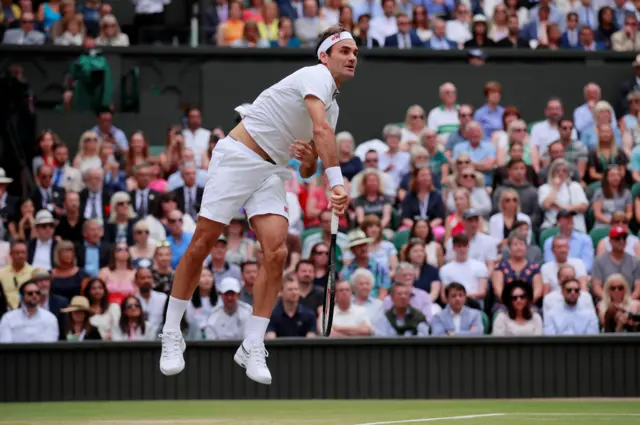 Roger Federer serves