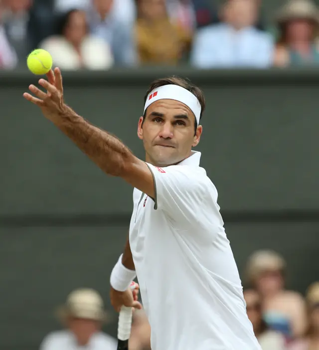 Roger Federer serves