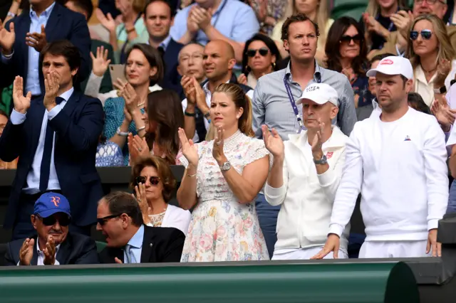 The Federer family and support team stand to applaud