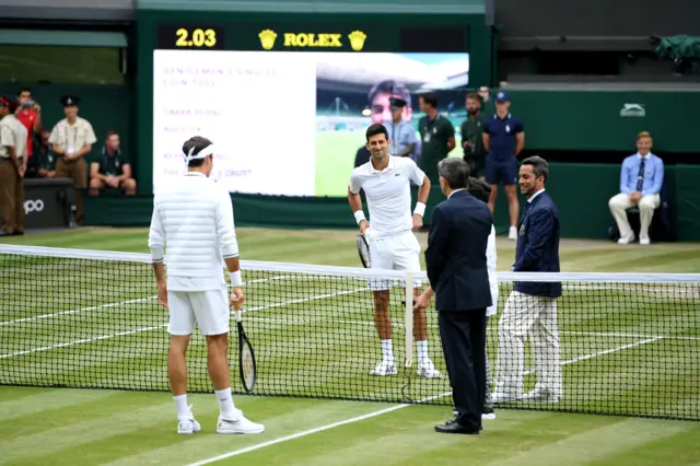 Roger Federer and Novak Djokovic at the net for the coin toss