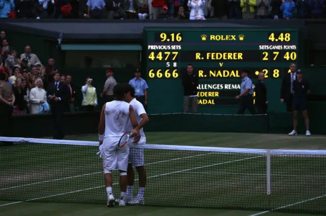 Roger Federer and Rafael Nadal embrace at the net after the longest Wimbledon final in 2008