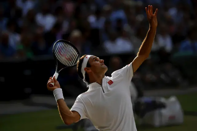 Roger Federer serves