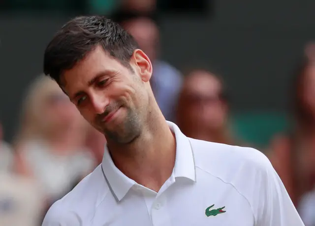 Novak Djokovic gives a tired smirk