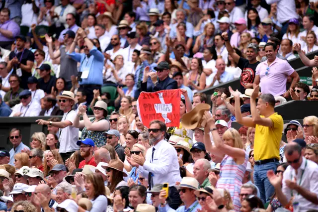 Roger Federer fans wave a Swiss flag