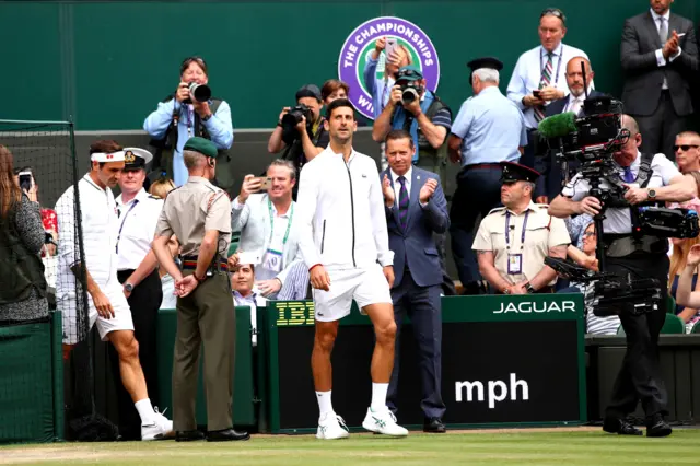 Roger Federer and Novak Djokovic walk on to Centre Court