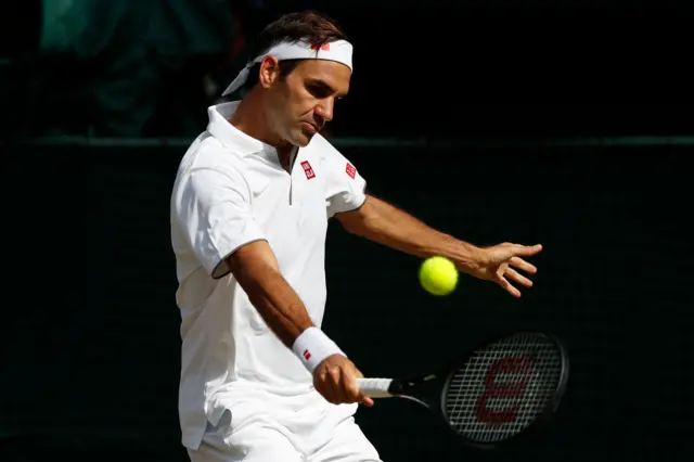 Roger Federer hits a backhand