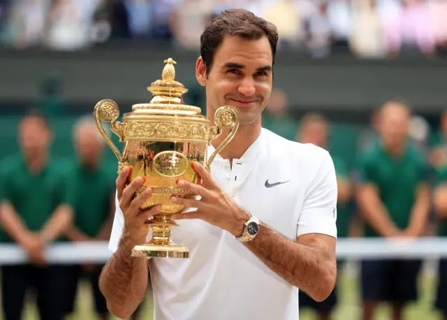 Roger Federer with the Wimbledon men's singles trophy