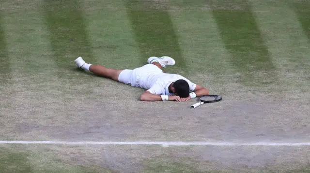 Djokovic lies on the grass