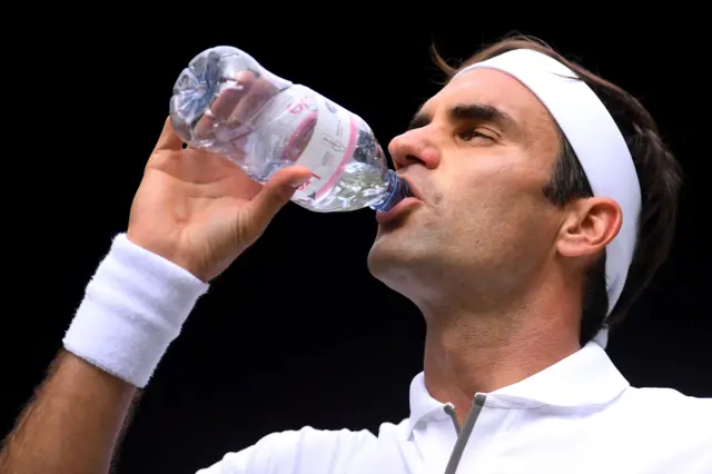 Roger Federer takes a well-earned drink