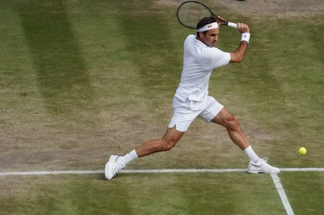 Roger Federer hits a backhand shot